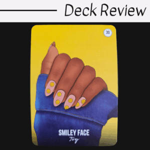 A card from The Signs of the Times Oracle featuring an illustration of a hand with yellow smiley faces on long nails, partially covered by a blue sleeve. The background is yellow, displaying "SMILEY FACE Joy" and the number 30.