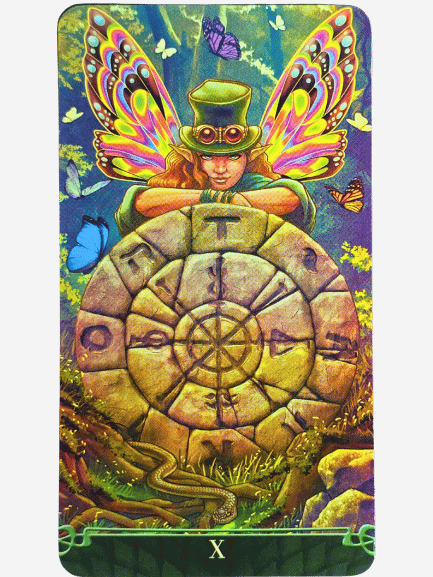 A fantasy scene from Tarot at the End of the Rainbow shows a figure with colorful butterfly wings and a green top hat leaning on a stone wheel with symbols. Butterflies dance as a snake slithers nearby, beneath the Roman numeral X.