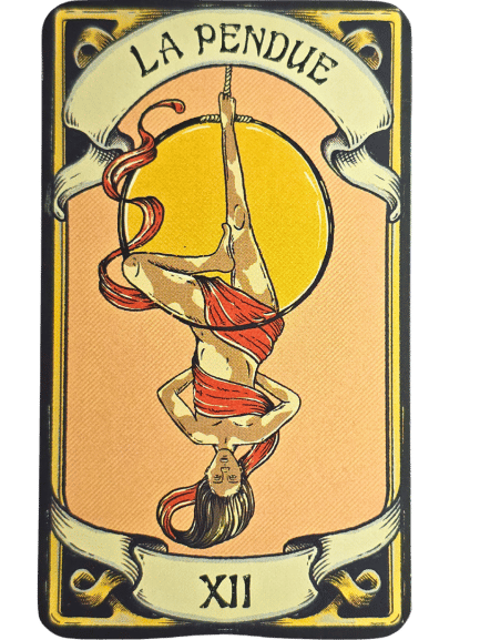 Illustration from The Sacred Sisterhood Tarot of The Hanged Man (La Pendue), depicting a person hanging upside down by one foot, draped in red cloth, with a yellow circle behind them and the number XII at the bottom.