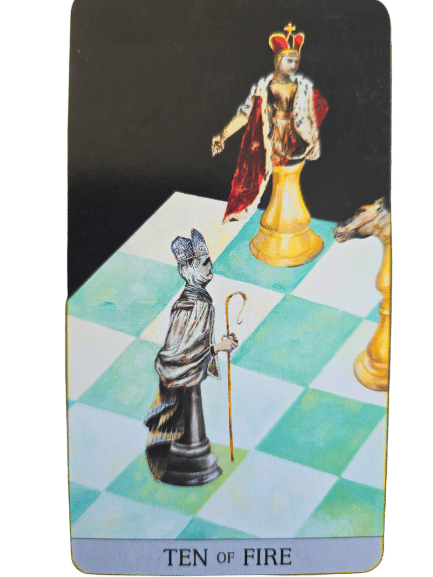 A Japaridze Tarot card labeled Ten of Fire shows chess pieces: a black bishop holding a staff, a yellow king with crown and red robe, and a yellow knight on a green and white chessboard.