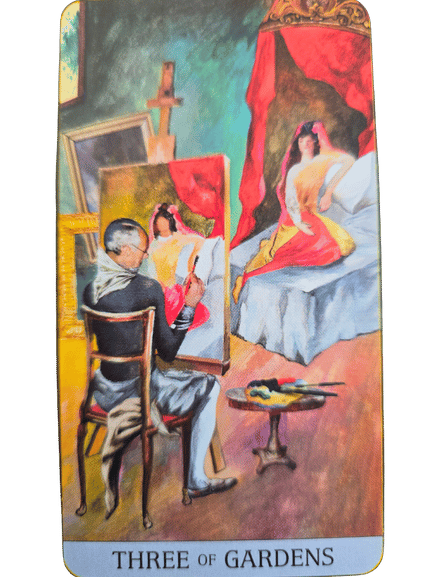 A man sits at an easel painting a woman in a red and yellow dress who poses on a bed. The vibrant scene, filled with art supplies and a framed painting, captures the essence of the Japaridze Tarot’s Three of Gardens.