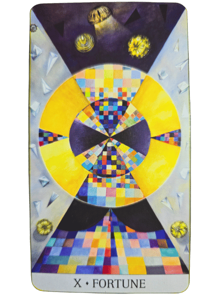 A tarot card titled X FORTUNE from the Japaridze Tarot features a geometric design with bright yellow, blue, and multicolored squares forming circular and triangular patterns. Four gold wheels appear near the corners on a dark background.