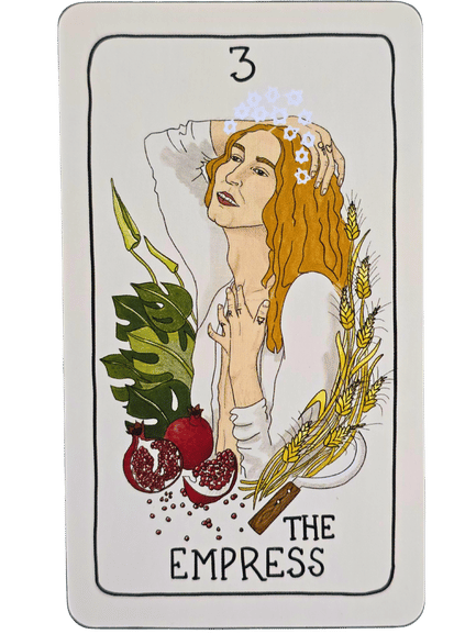 A tarot card from the Fifth Spirit Tarot, titled The Empress, shows a serene woman with auburn hair, a crown of flowers, surrounded by greenery, wheat, pomegranates, and cinnamon—symbolizing nature, abundance, and femininity.