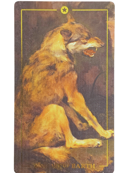 A tarot card from the Folkloric Forest Tarot featuring an illustration of a snarling wolf sitting on its haunches. The card has a yellow border and star at the top, with text at the bottom that is partially obscured.